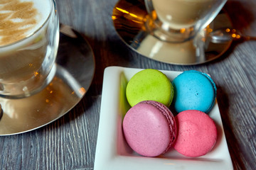 Two cups of coffee plate of macaroons