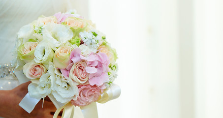 Bride in wedding dress holding flower bouquet 