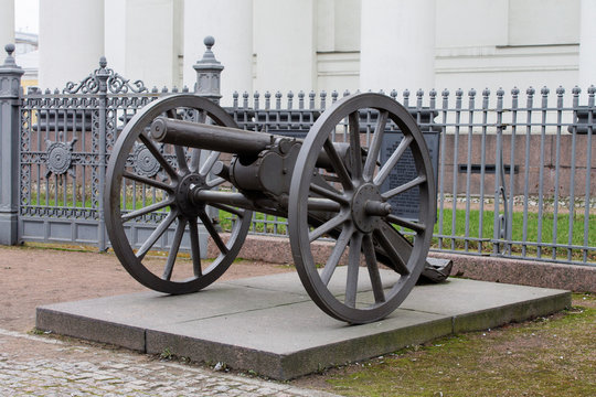 antique firearms cannon on a concrete pedestal