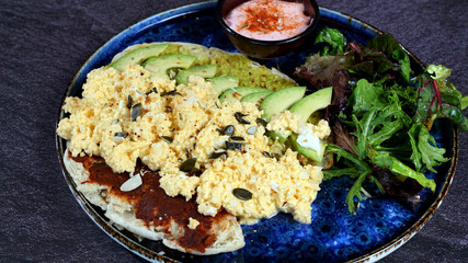 Avocado egg, tomato sauce and fresh salad