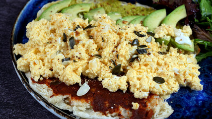 Avocado egg, tomato sauce and fresh salad