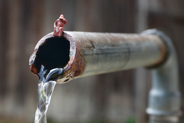 Little People: Mönch sitzt auf Wasserhahn und trinkt