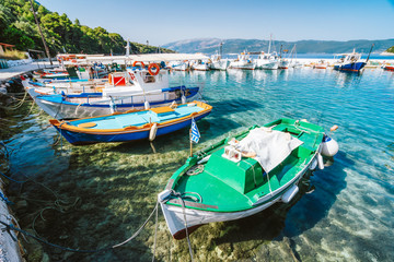 Naklejka na ściany i meble Colorful Greek local fishing boats in small port harbor of Kioni on Ithaka island, Greece