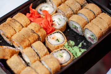 sushi in a black container