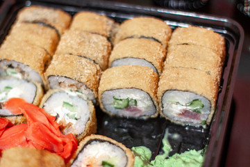 sushi in a black container