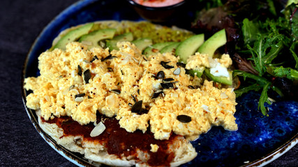 Avocado egg, tomato sauce and fresh salad