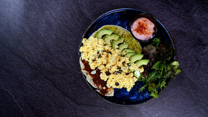 Avocado egg, tomato sauce and fresh salad