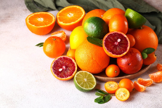 natural organic citrus fruit on a wooden plate © Olga Kriger