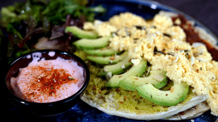 Avocado egg, tomato sauce and fresh salad