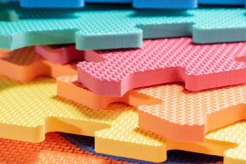 Macro photo of the details of a foam. Colored rubber mat puzzle for children.