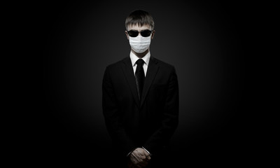 man in black costume in medical mask