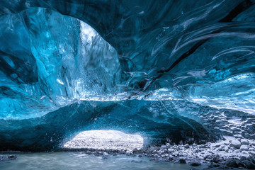 Inside an ice cave in Vatnajokull, Iceland, the ice is thousands of years old and so packed it is harder than steel and crystal clear. Winter travel around the world.  Beautiful landscape background