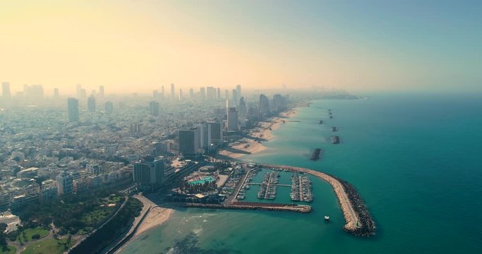Israel skyline from a drone Early morning sunrise. Panoramic Aerial view above coastline of Tel Aviv modern and business city with hotels, seashore and beach. Middle east skylines