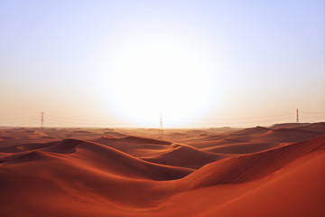 Naklejka premium Sunrise on the red sand dunes of the Arabian desert in Riyadh, Saudi Arabia. New beginnings, sign of hope, bright future and sunshine after a storm concept.