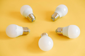 LED light bulbs on yellow background. Top view. Copy, empty space for text