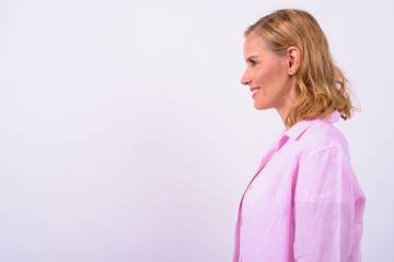 Profile view of happy beautiful blonde woman smiling