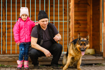 The man affects the dog, obedient and loving dog, captive dogs pull their heads through the bars,...