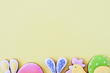 Easter background concept. Colored easter cookies on yellow background. - 333225921