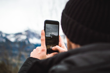 man taking picture on cell phone