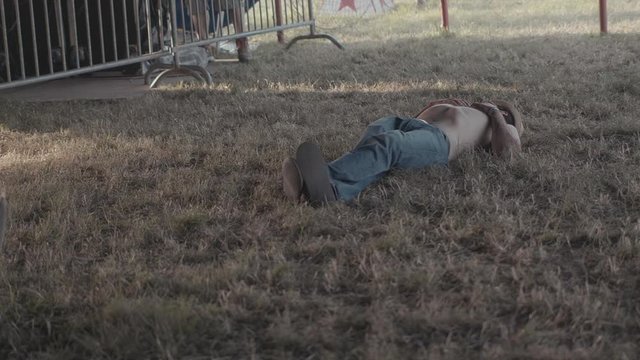 Man at festival sleeping on the grass