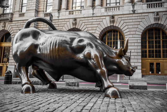 NEW YORK CITY - MARCH 24, 2020: Charging Bull sculpture on March 24, 2020 on empty streets of  New York City during Corona virus Epidemic.