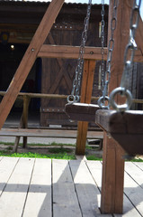 vintage wooden swing on a chain of bright sun