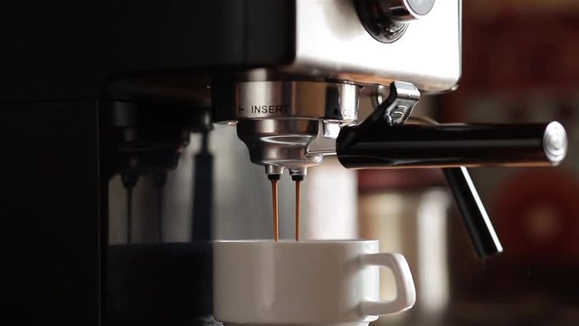 maker pouring coffee in a cup