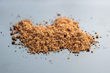 cinnamon seasoning powder slide on glass on black background