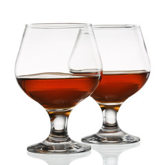 Two glasses of cognac isolated on white