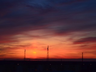  Orange sunset, colorful sky. The clouds. Electric tower.