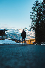 man standing and looking mountains