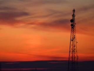 Orange sunset, colorful sky. The clouds. Electric tower.