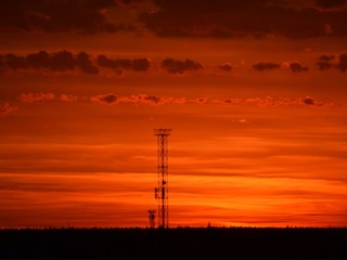  Orange sunset, colorful sky. The clouds. Electric tower.