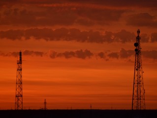 Orange sunset, colorful sky. The clouds. voltage electric tower. Golden sky and white clouds. Beautiful cloudscape. Nature background. Transmission lines. Peaceful and tranquil abstract background. S