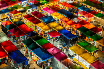 Fototapeta na wymiar Bird eyes view of Multi-colored tents /Sales of second-hand market at twilight.