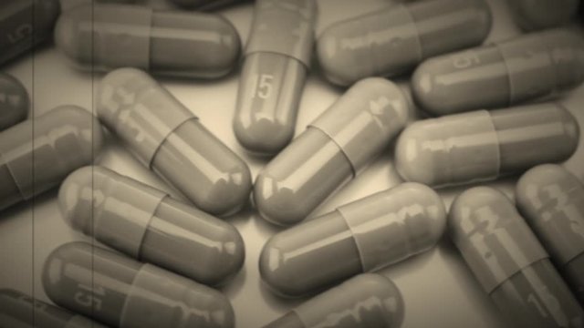 Vintage Close Up View of Capsules Moving Left to Right with Retro 8mm Effect Scratches and Noise