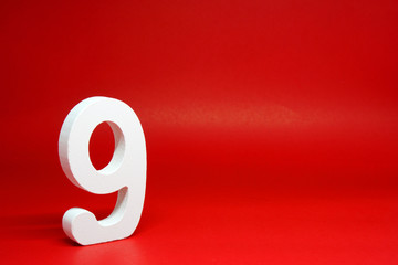 Nine ( 9 ) white wooden  Isolated Red Background with Copy Space - New promotion 9% Percentage  Business finance Concept