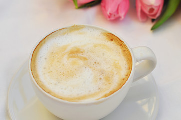 cup of coffee with cream on white background