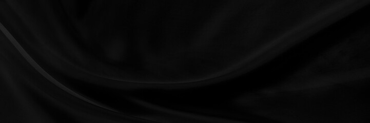 Black gray satin dark fabric texture luxurious shiny that is abstract silk cloth panorama background with patterns soft waves blur beautiful.