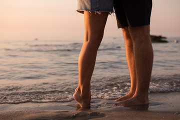 couple legs on the beach