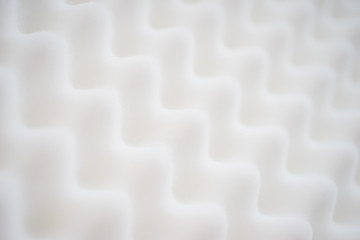 White gradient abstract background with many waves at different angles.