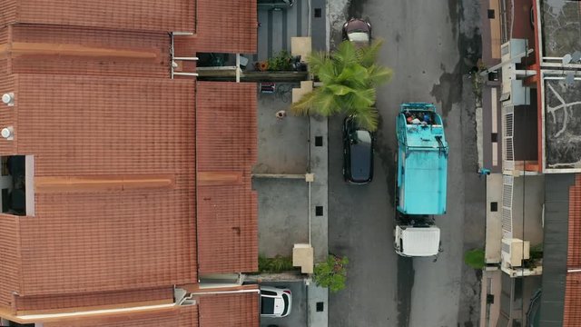 Aerial view of garbage truck collecting rubbish at a residential housing area in Malaysia