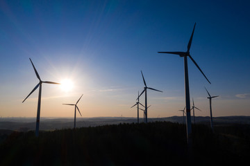 Obraz premium wind wheels in an evening countryscape