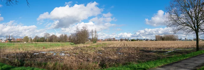 Foto op Canvas Panoramic photo of Sint Gillis waas village on the border with the Netherlands in East Flanders, Belgium, Photo taken in spring with beautiful clouds © Farantsa