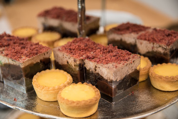 Fruit tartlets dessert and pastry cake sweets on trays