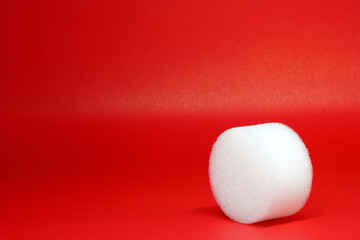 White Spherical plastic or Shockproof foam isolated red background -geometric shapes and decor 