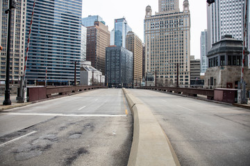 Fototapeta na wymiar Chicago,IL/USA-March 24th 2020: Streets of downtown Chicago around State street and Michigan ave are completely isolated, desolated, empty due the national health pandemic Covid-19. Business suffer