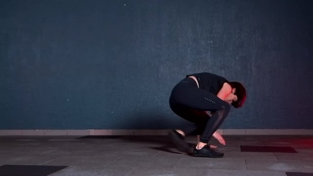 girl doing exercise in the yoga room. She makes body dance elements animal flow. Beautiful and graceful body movements in the style of animals.