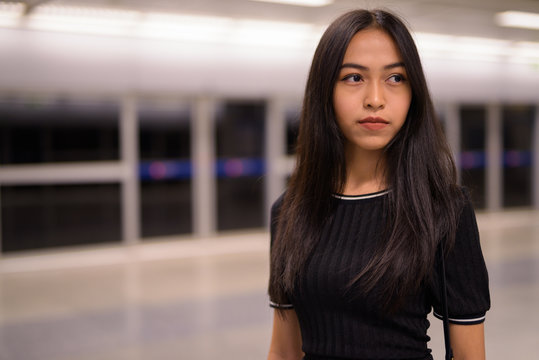 Young Beautiful Asian Tourist Woman Thinking At The Subway Station