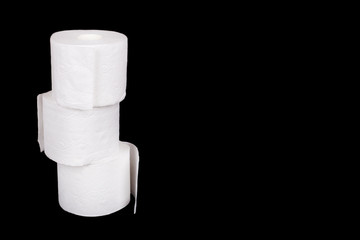 Stack of three rolls of toilet paper isolated on black background